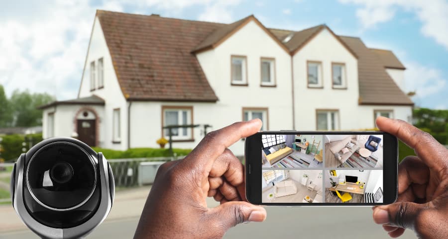 Man holding phone and checking streams from security cameras